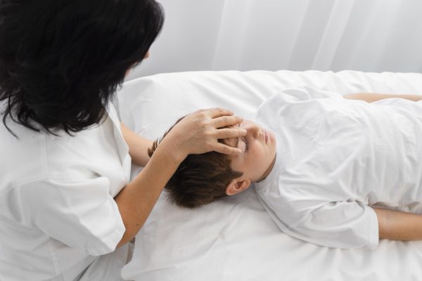 osteopathist-treating-boy-by-massaging-his-head